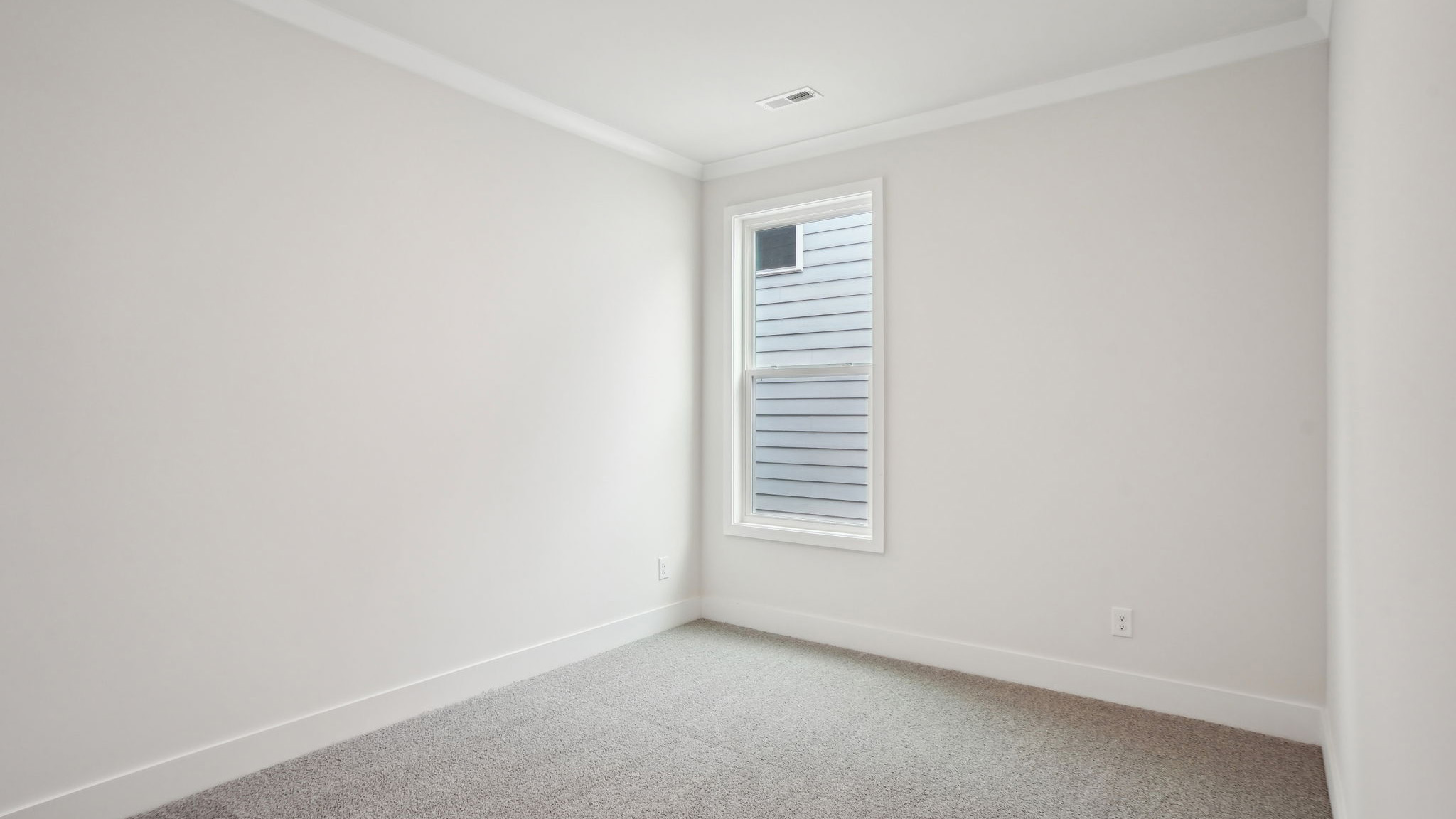 Carpeted bedroom with large window