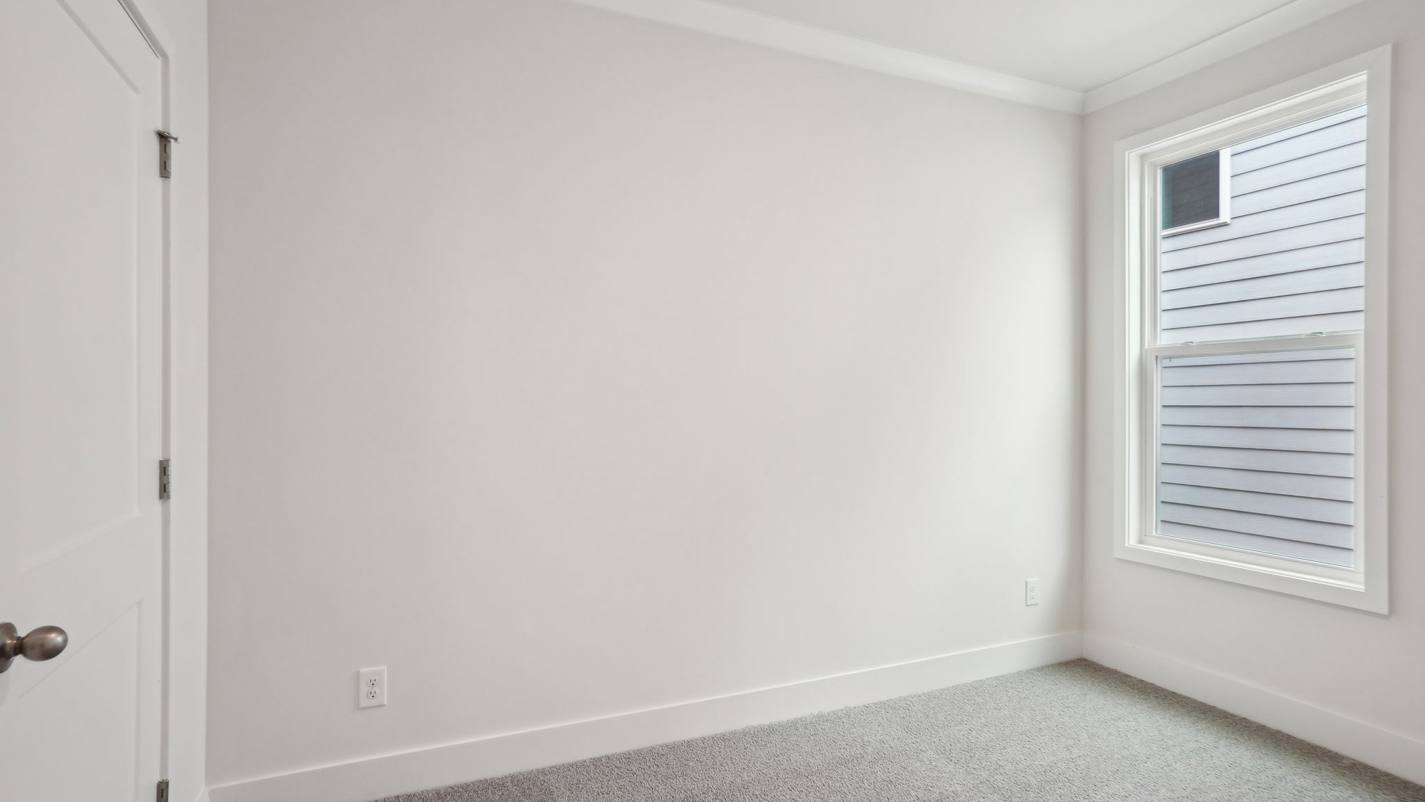 Carpeted bedroom with large window