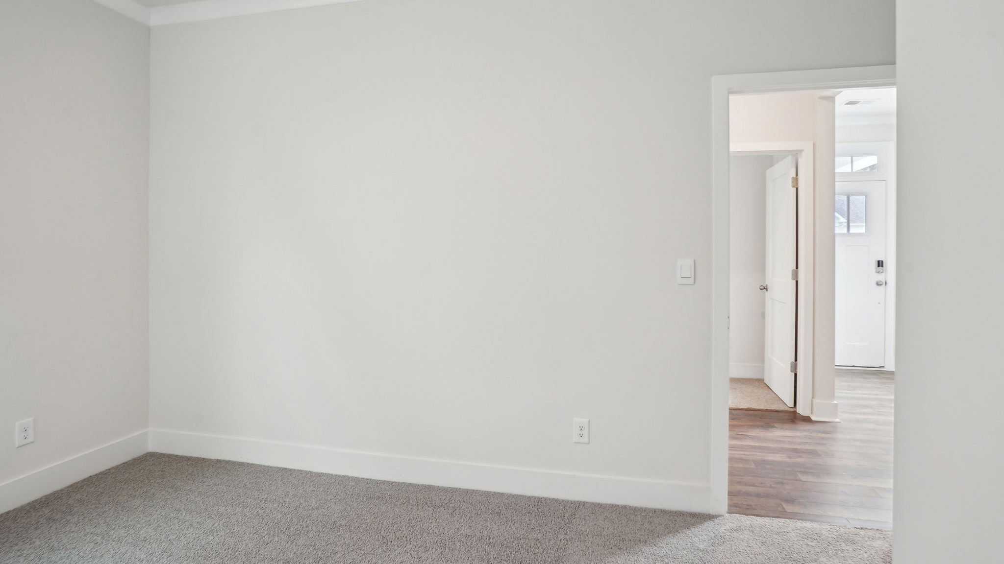 Carpeted bedroom with large window