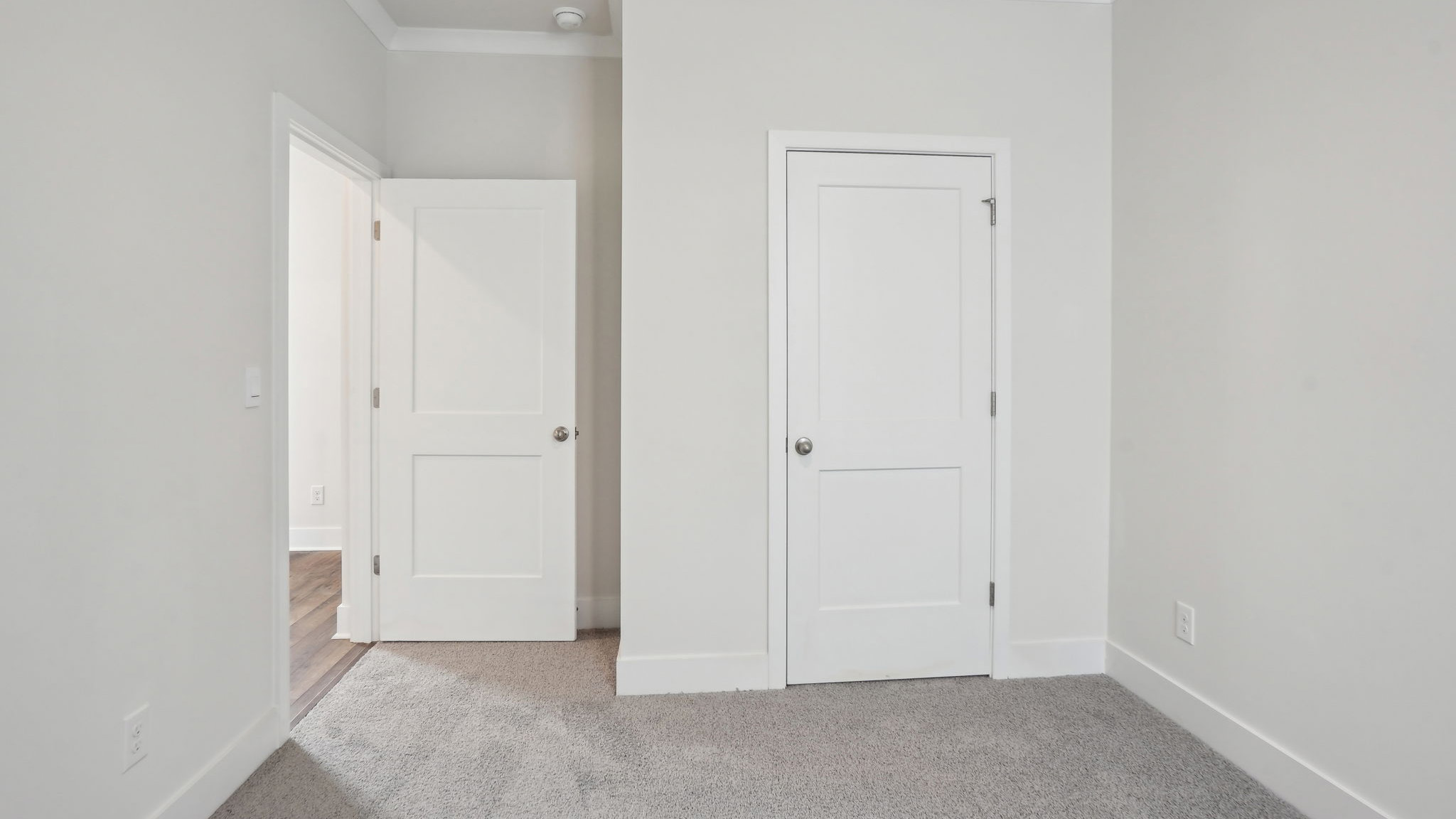 Carpeted bedroom with large window