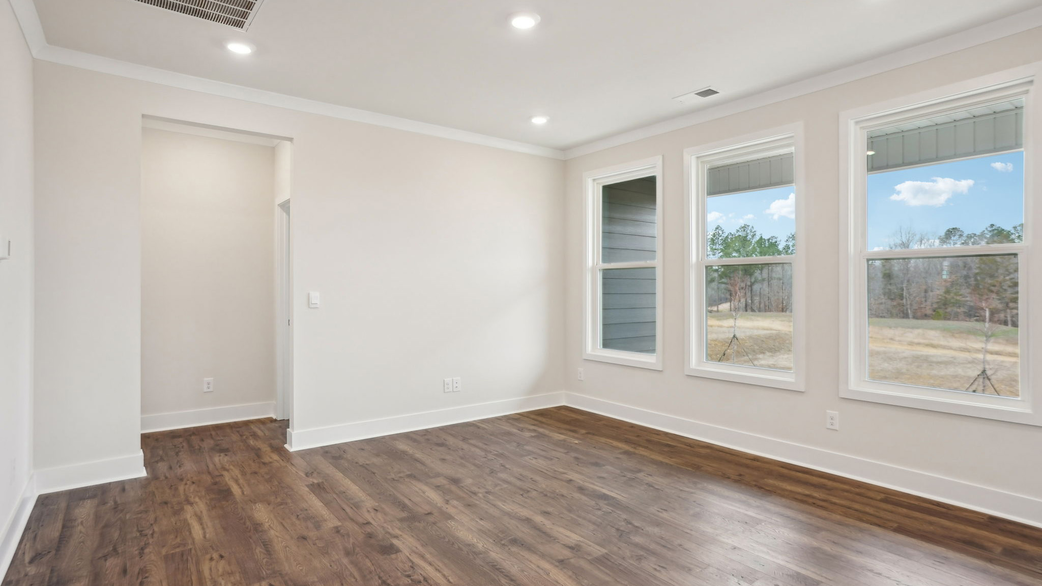 Dining area beside kitchen with chandelier and large window