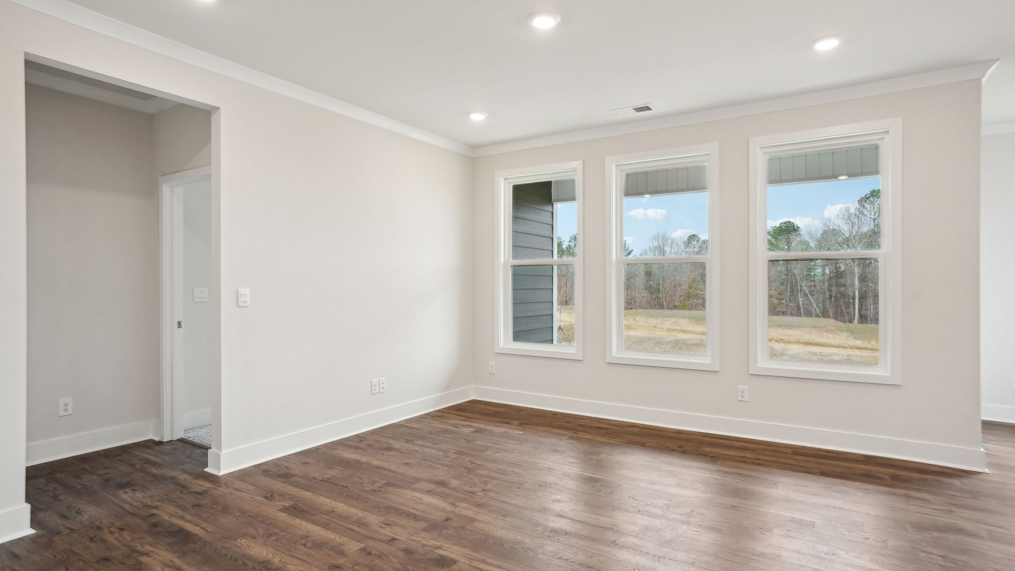 Dining area beside kitchen with chandelier and large window