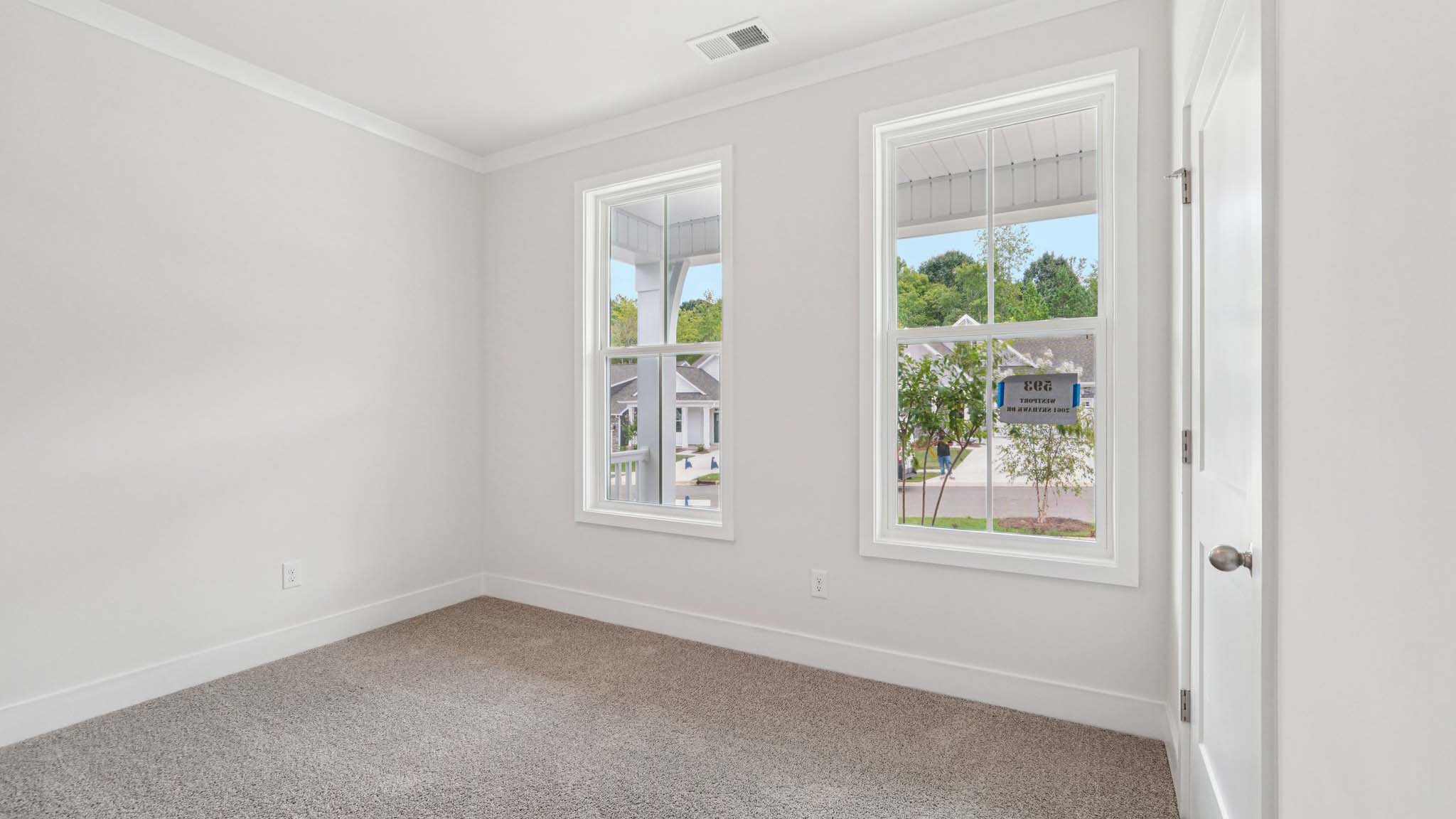 Carpeted bedroom with large window