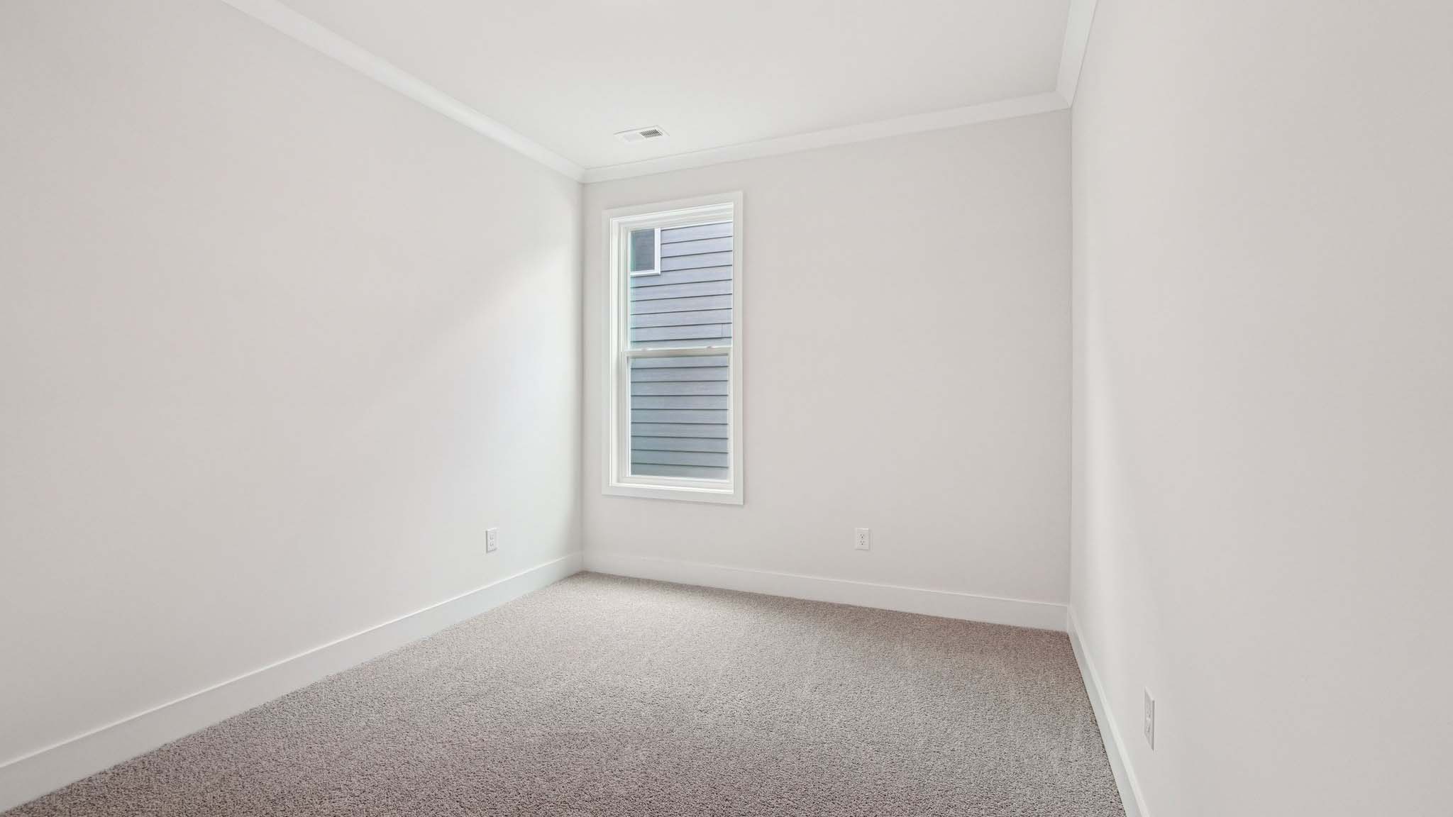 Carpeted bedroom with large window