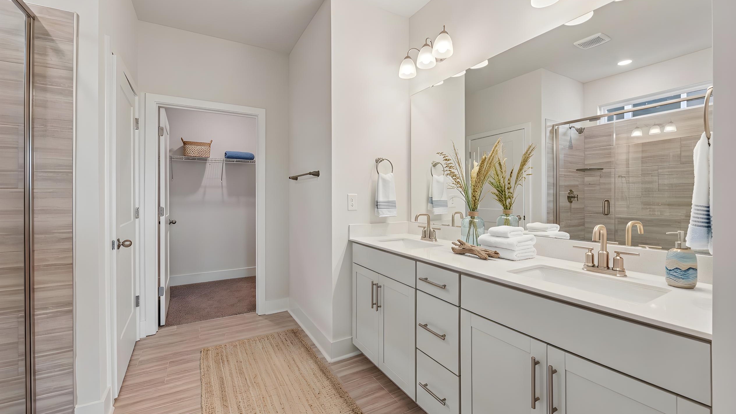 Primary bathroom with large counters and glass shower door