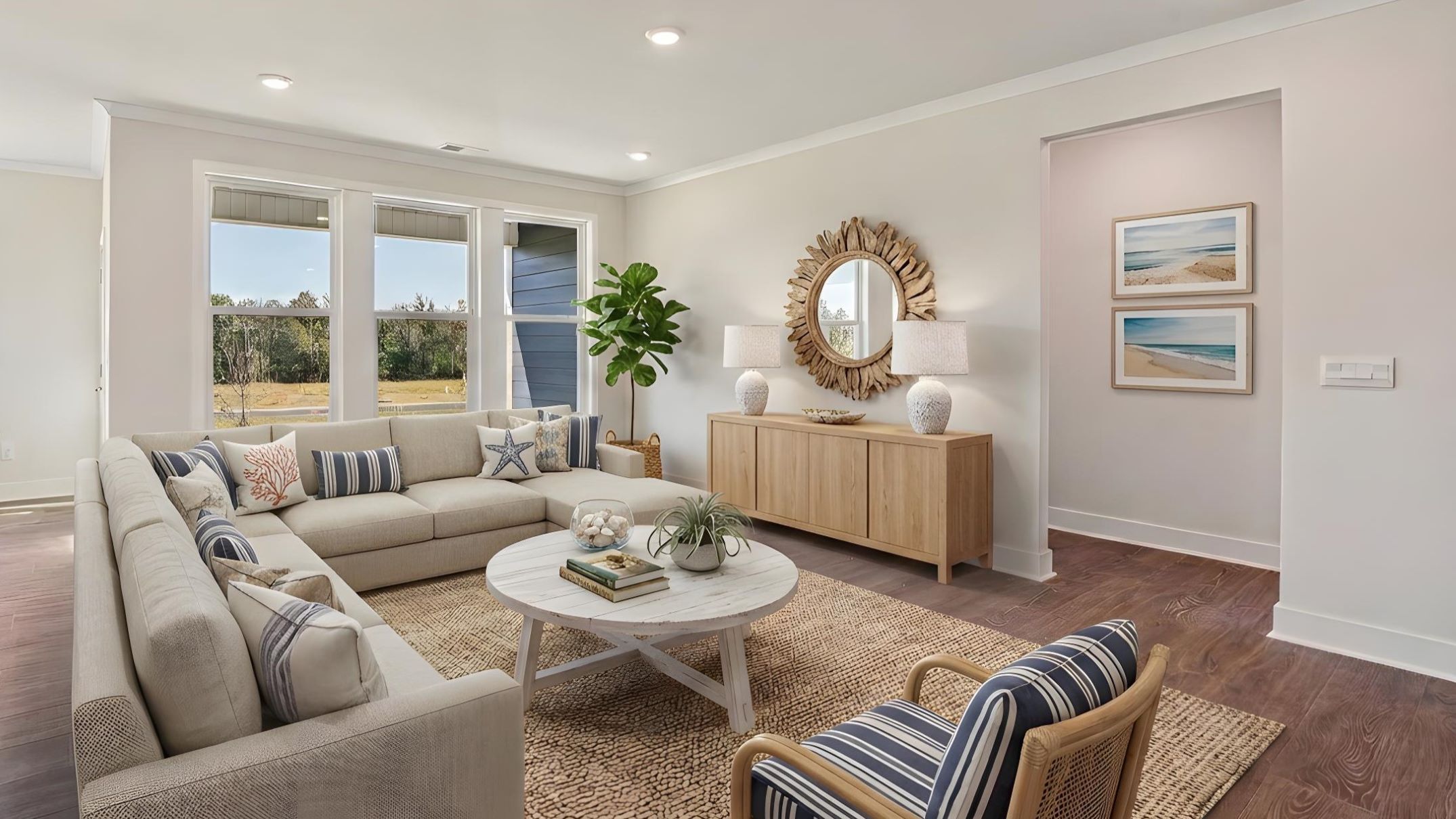 Open concept living room beside kitchen with large windows