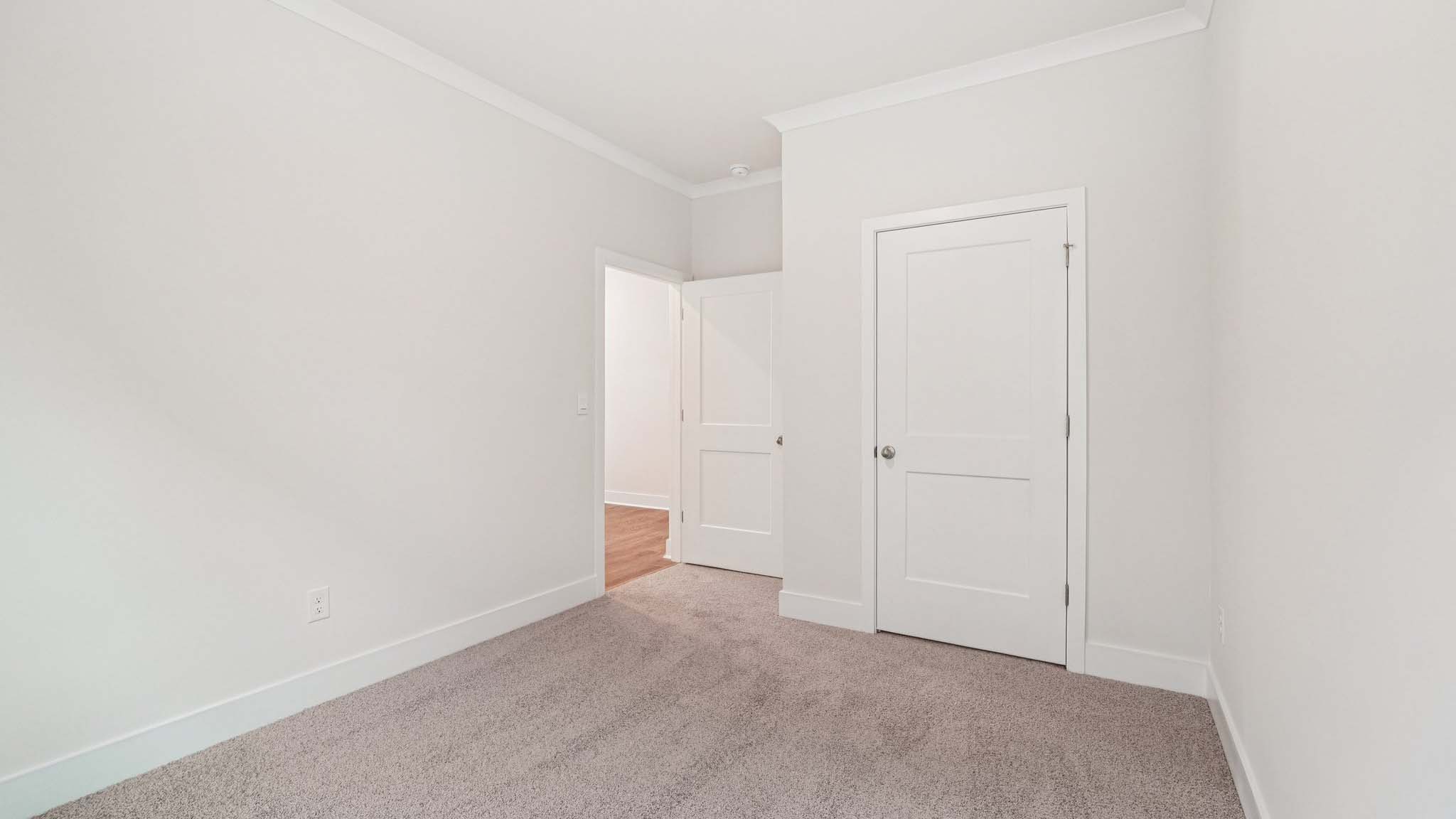Carpeted bedroom with large window