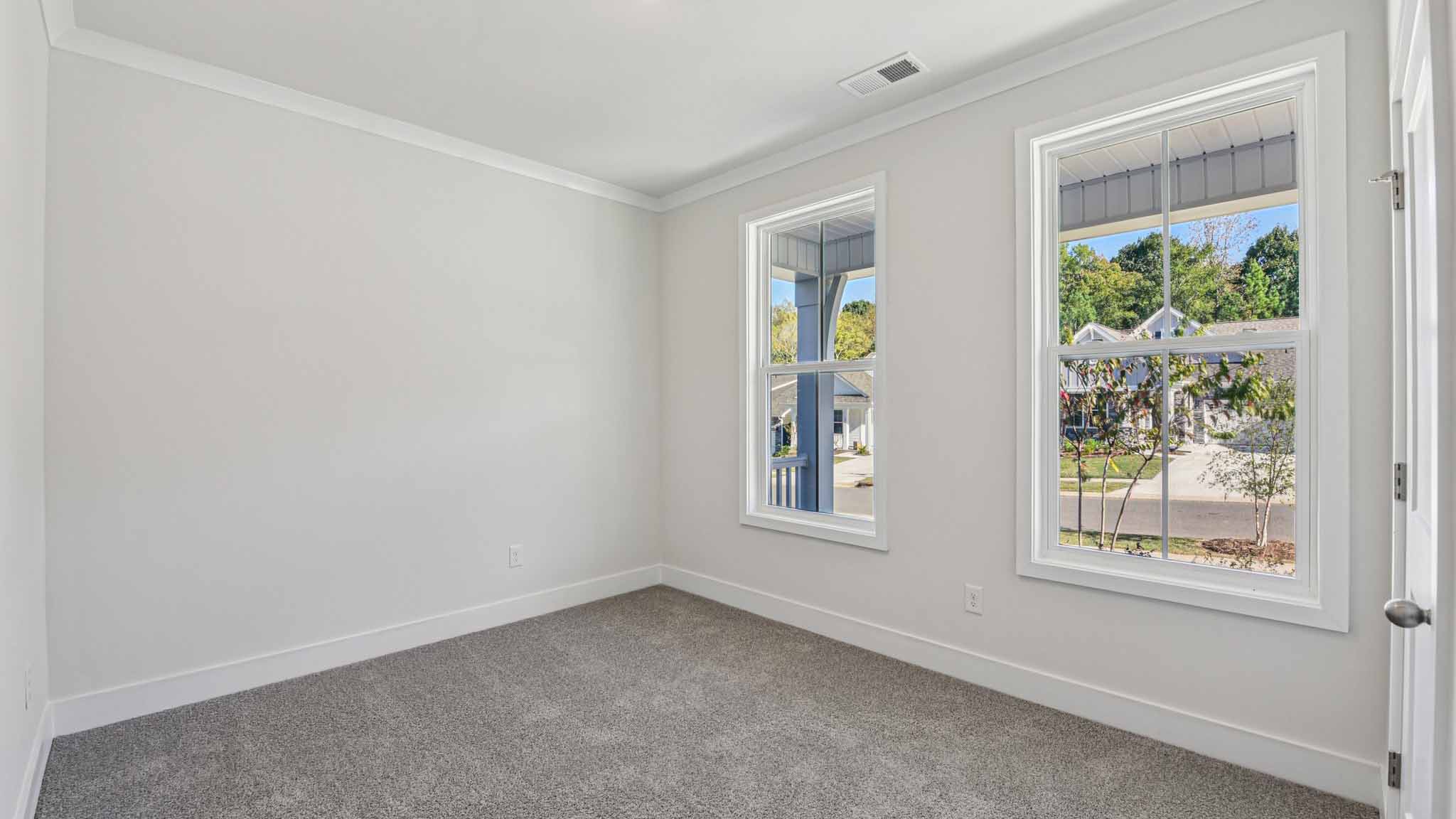 Carpeted bedroom with large window