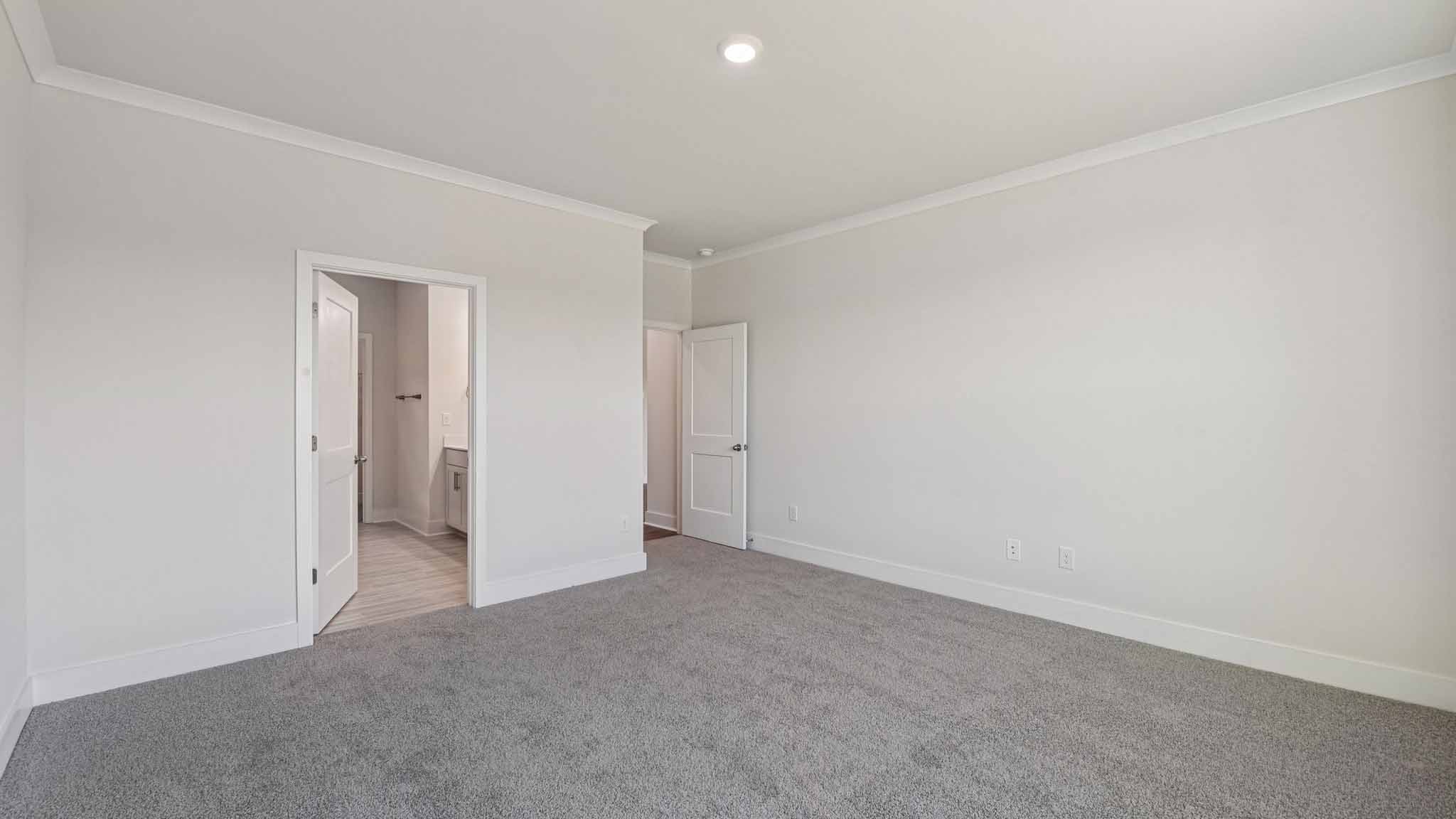 Carpeted bedroom with large window