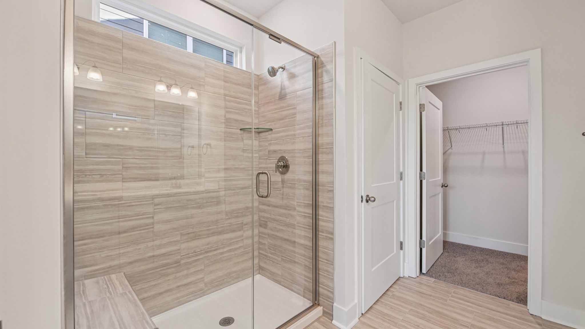 Primary bathroom with large counters and glass shower door