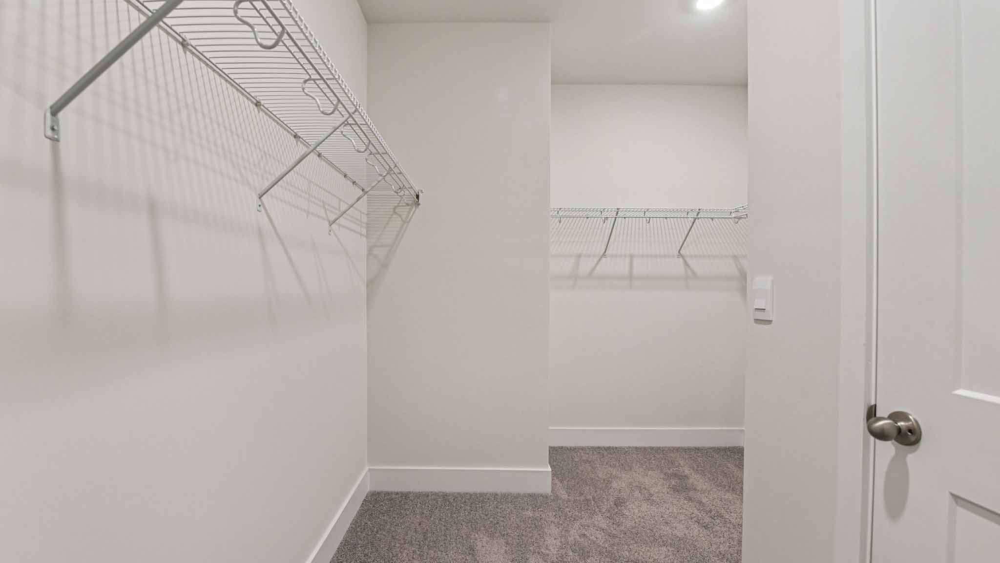 Primary bathroom with large counters and glass shower door