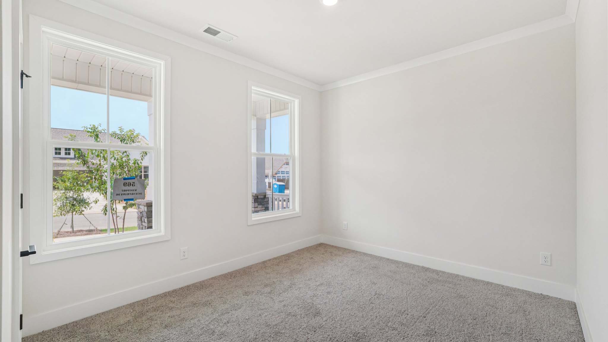Carpeted bedroom with large windows
