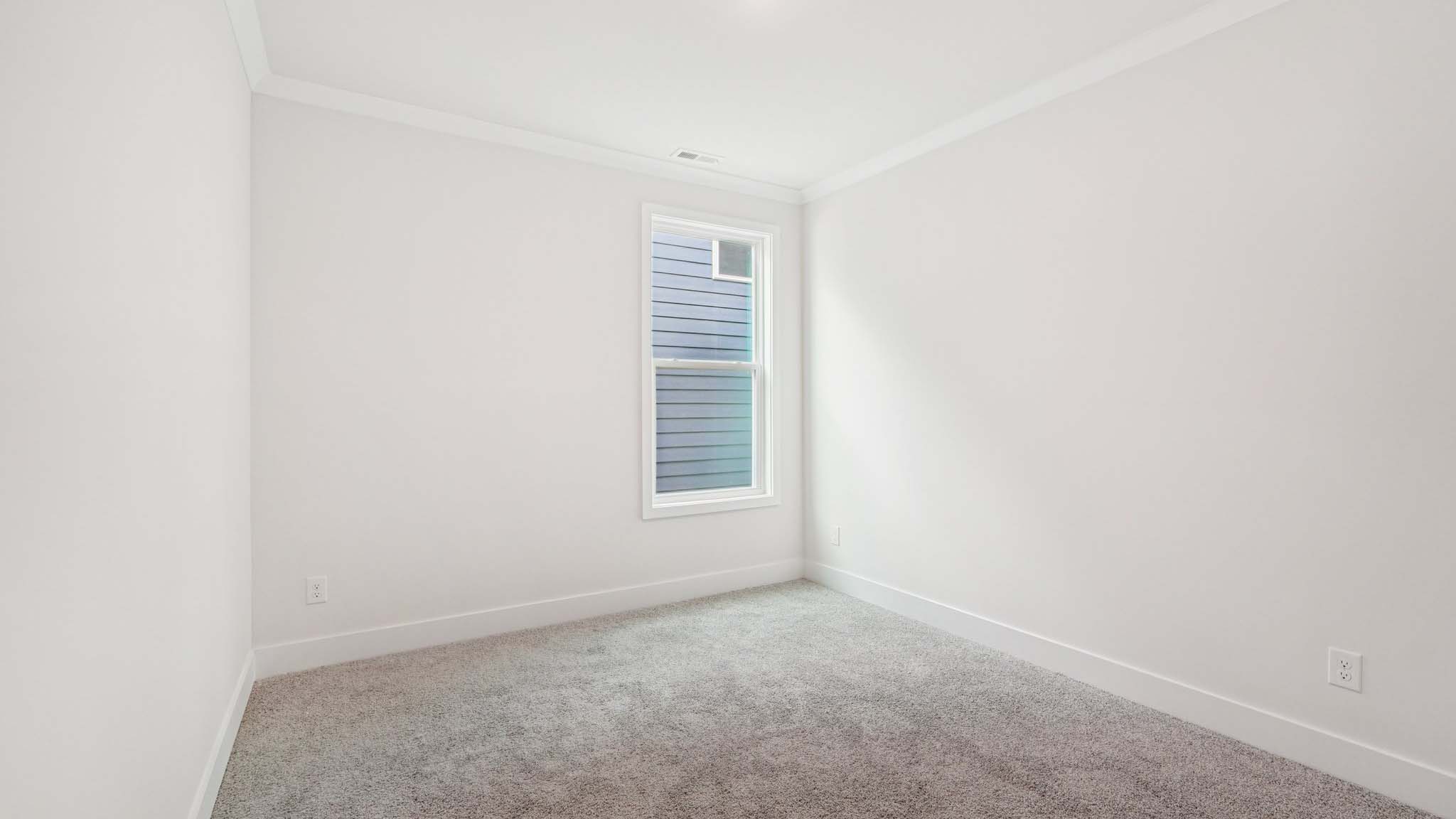 Carpeted bedroom with large windows