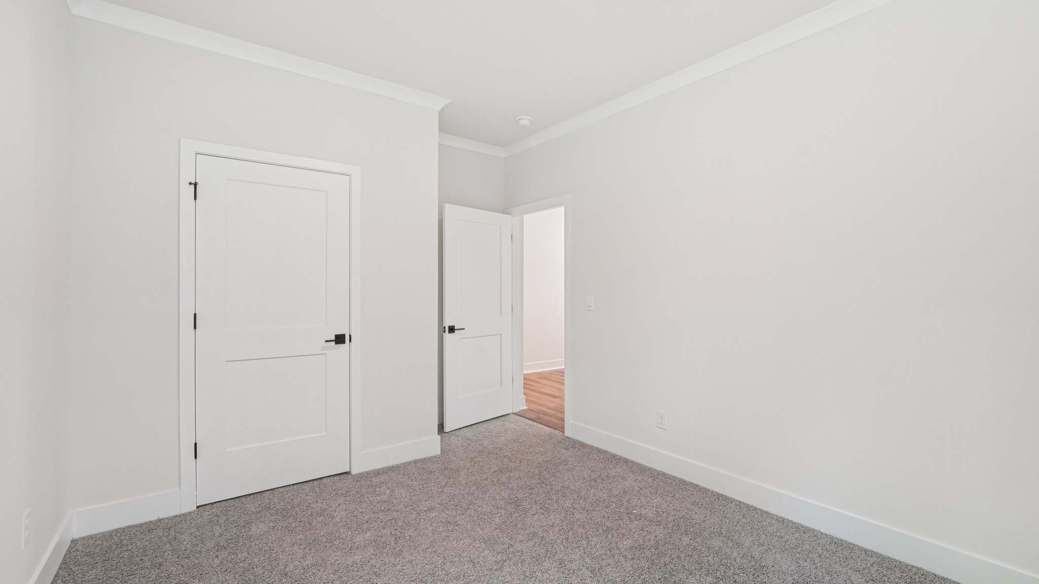Carpeted bedroom with large windows