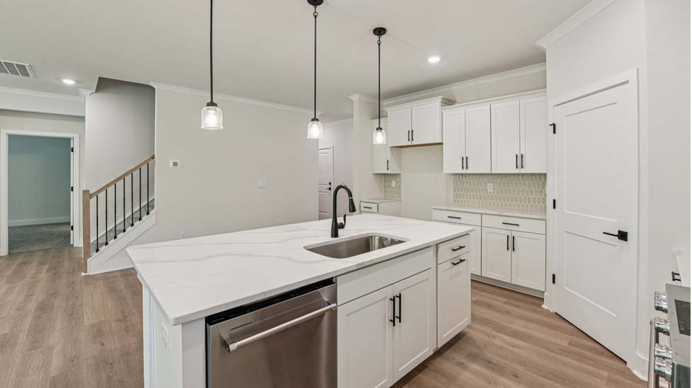 Kitchen and island with grey cabinets, white countertops, and stainless steel appliances