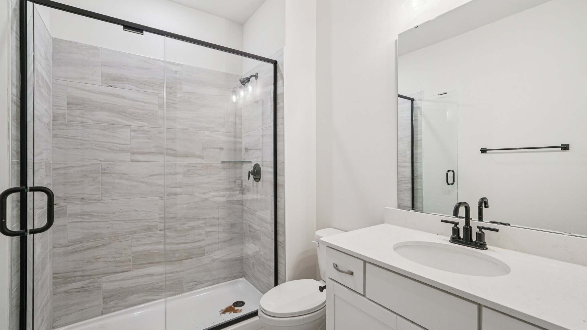 bathroom with double sinks and shower tub combination