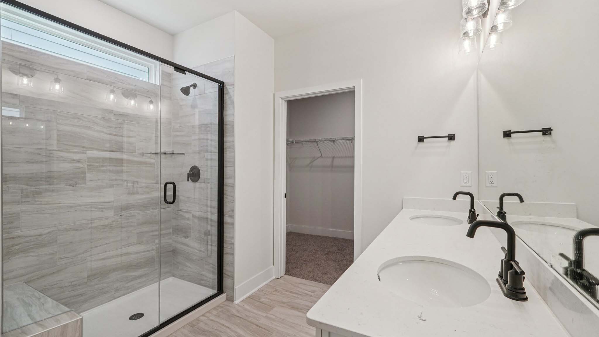 bathroom with double sinks and shower tub combination