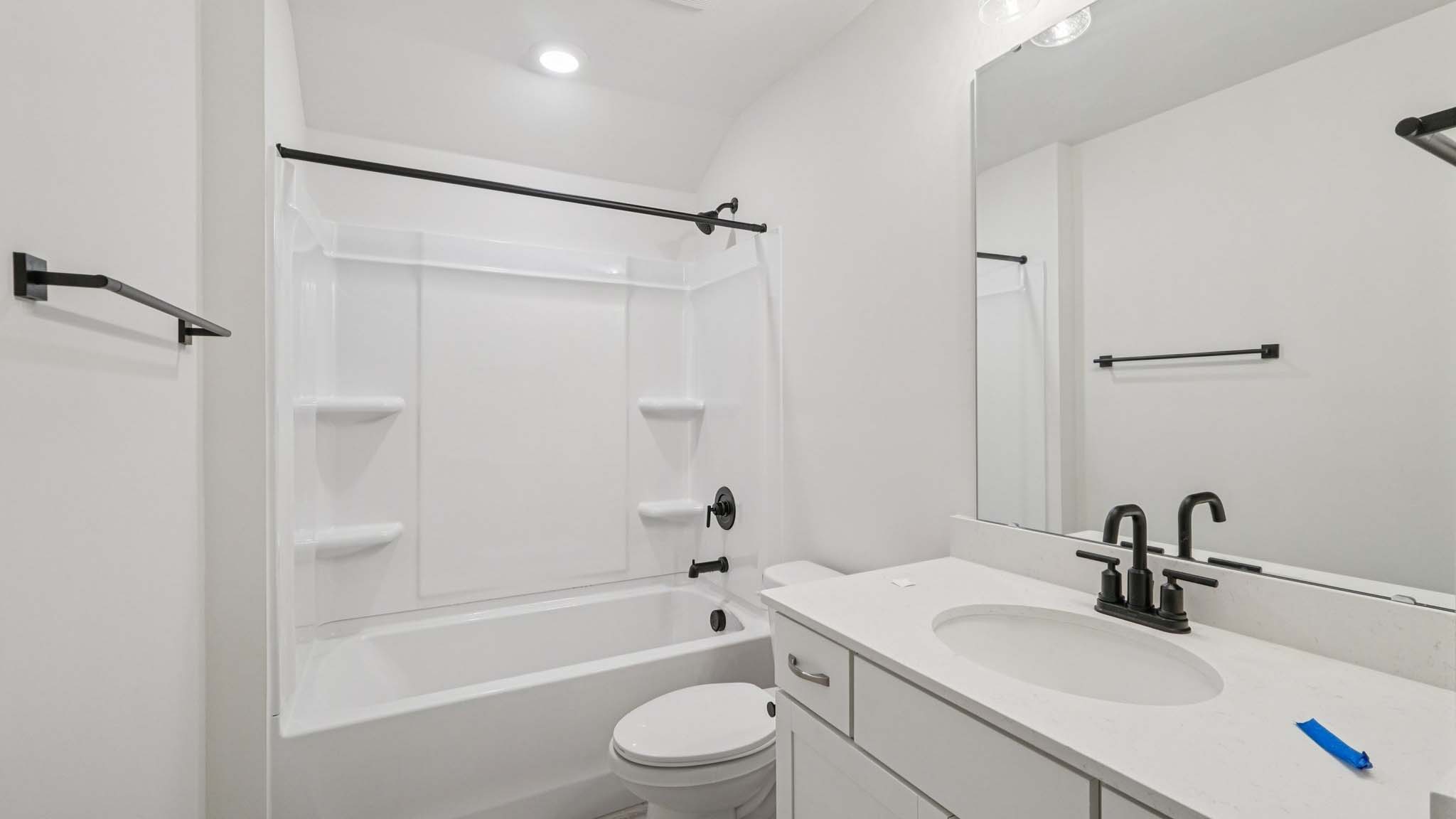 bathroom with double sinks and shower tub combination
