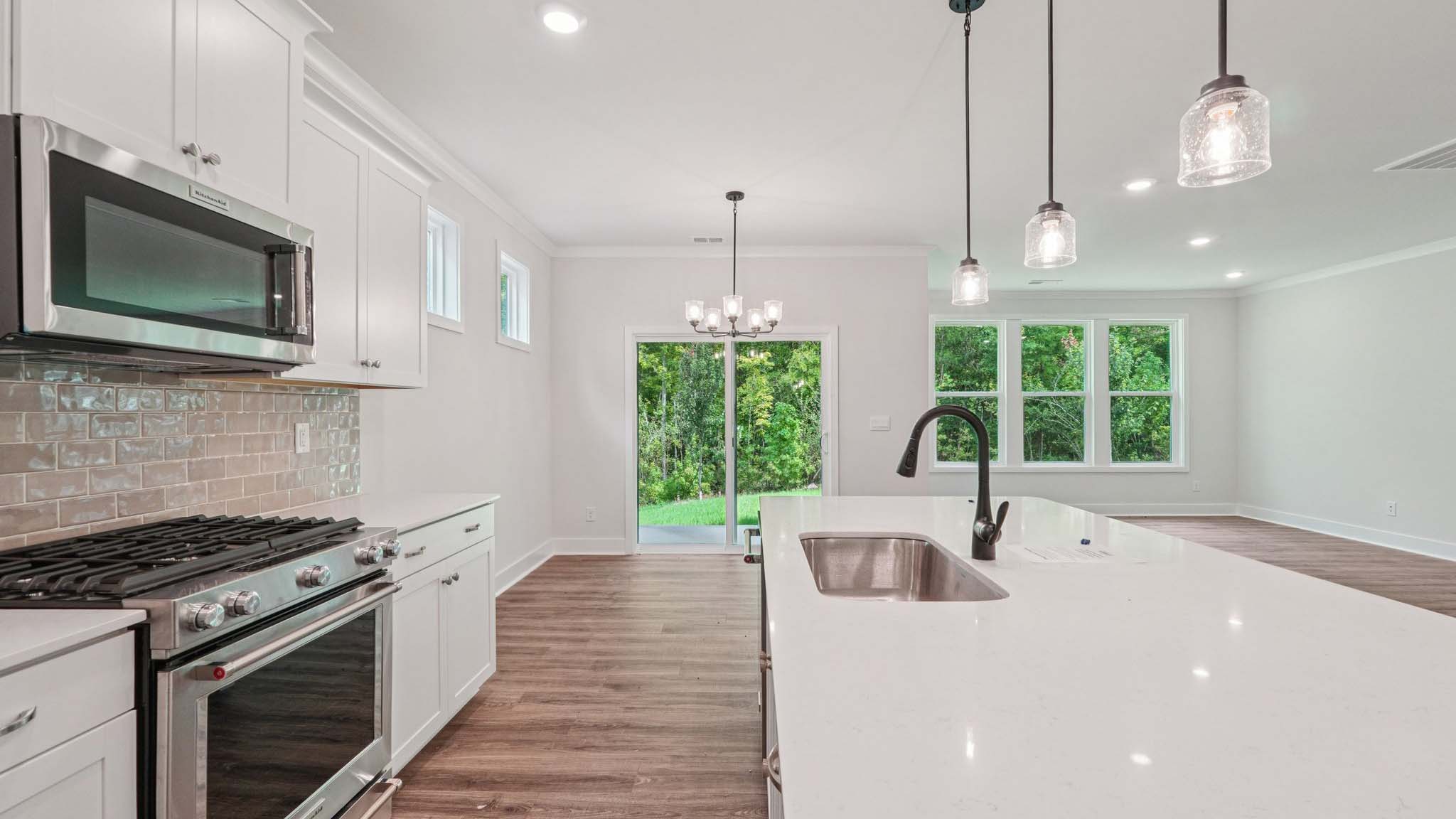 Kitchen and Island with white cabinets and stainless steel appliances