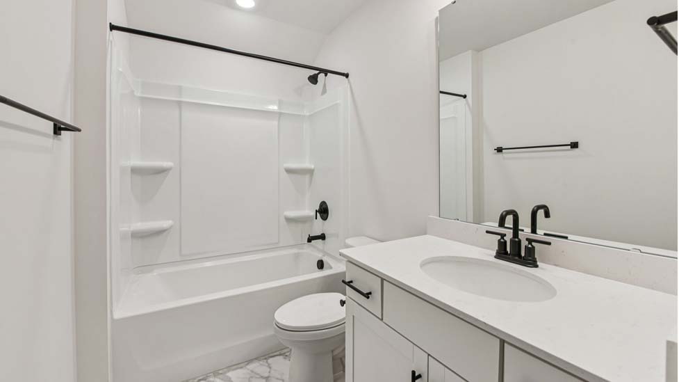 bathroom with double sinks and shower tub combination