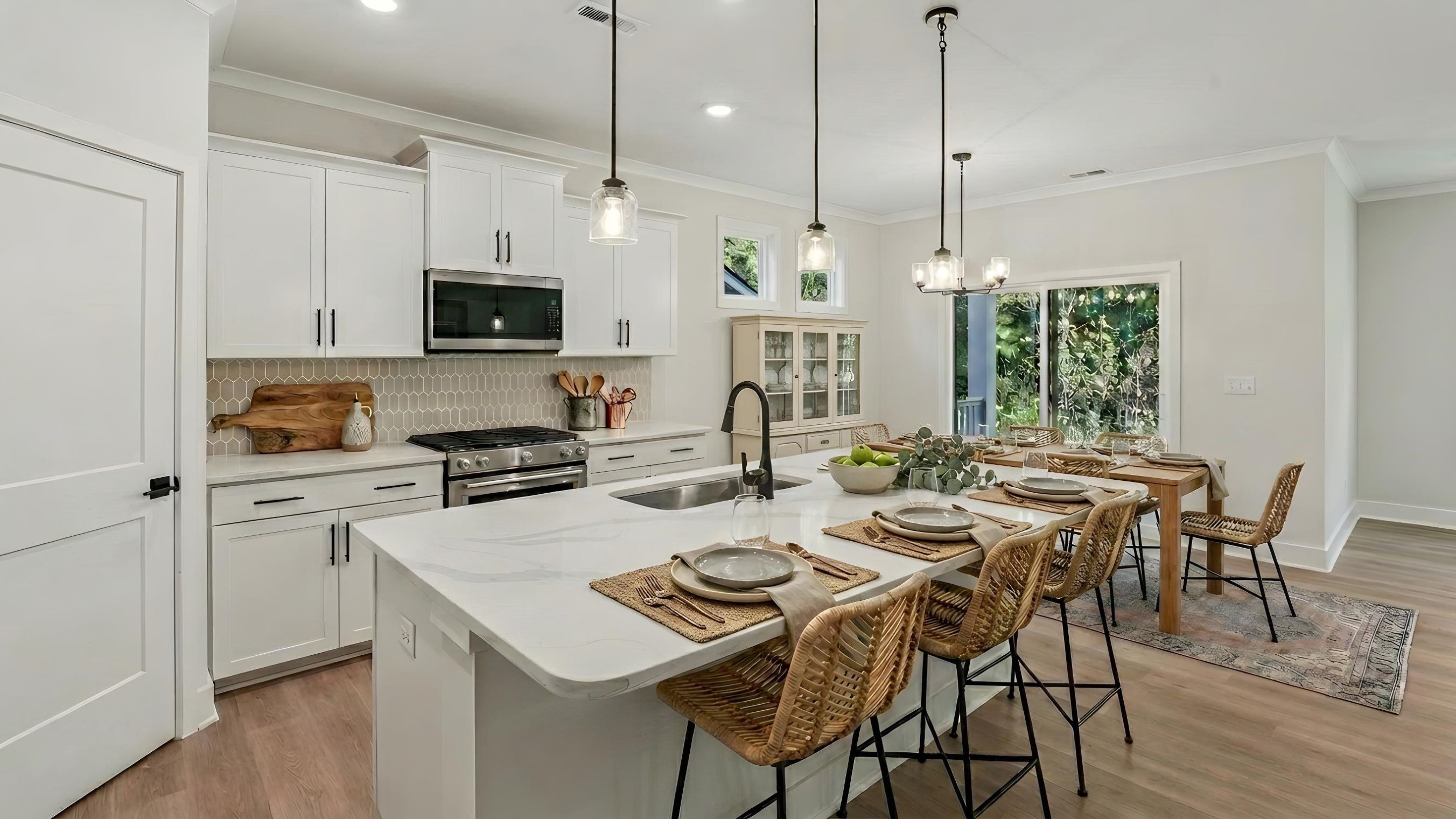 Kitchen and Island with white cabinets and stainless steel appliances