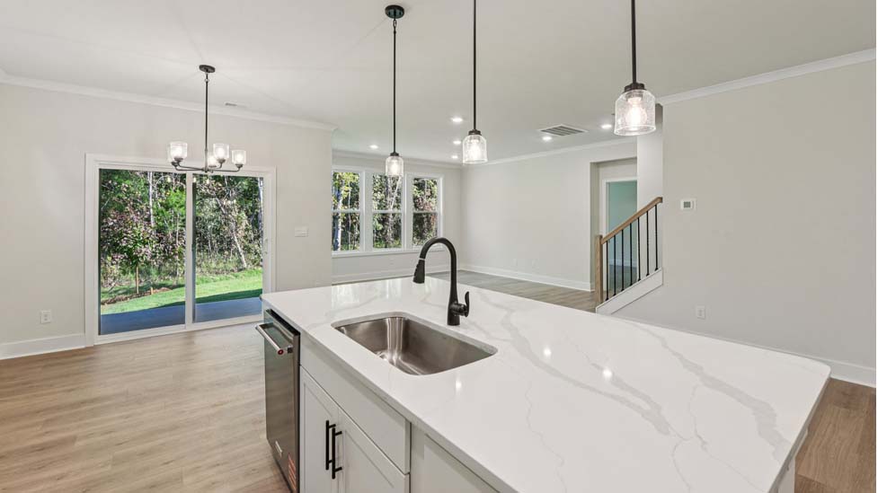 Kitchen and Island with white cabinets and stainless steel appliances