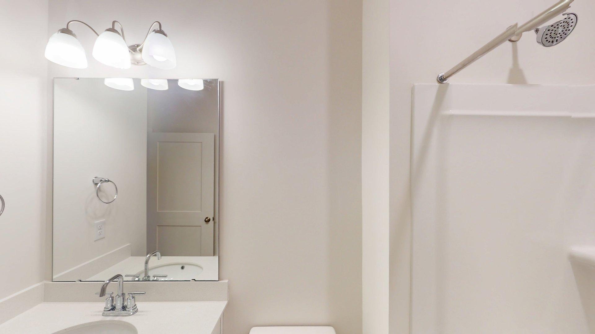 bathroom with double sinks and shower tub combination