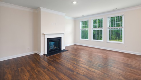 Open family room with three small windows and fireplace