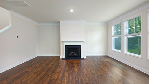 Open family room with three small windows and fireplace