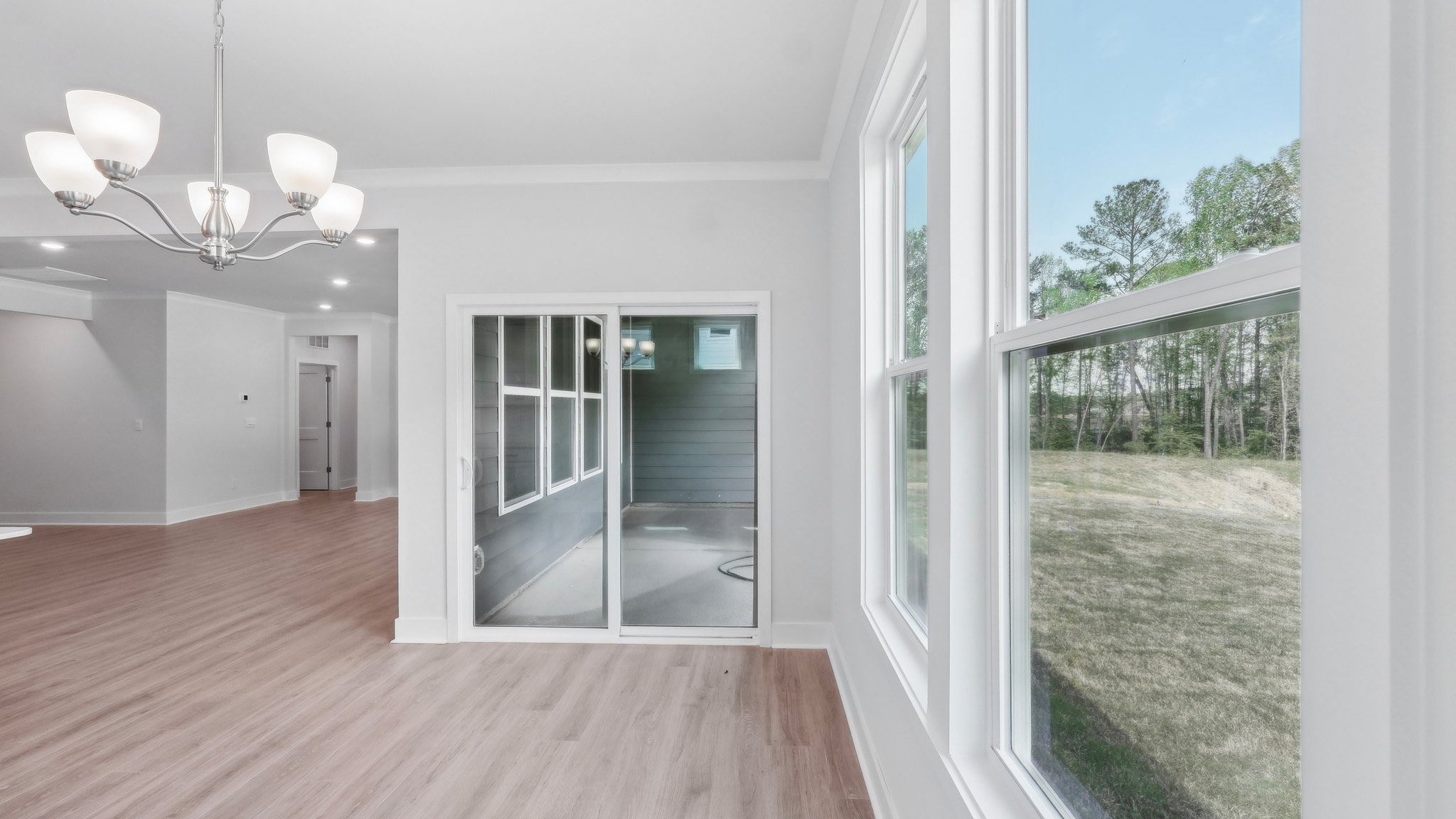 Large open family room beside kitchen with large windows