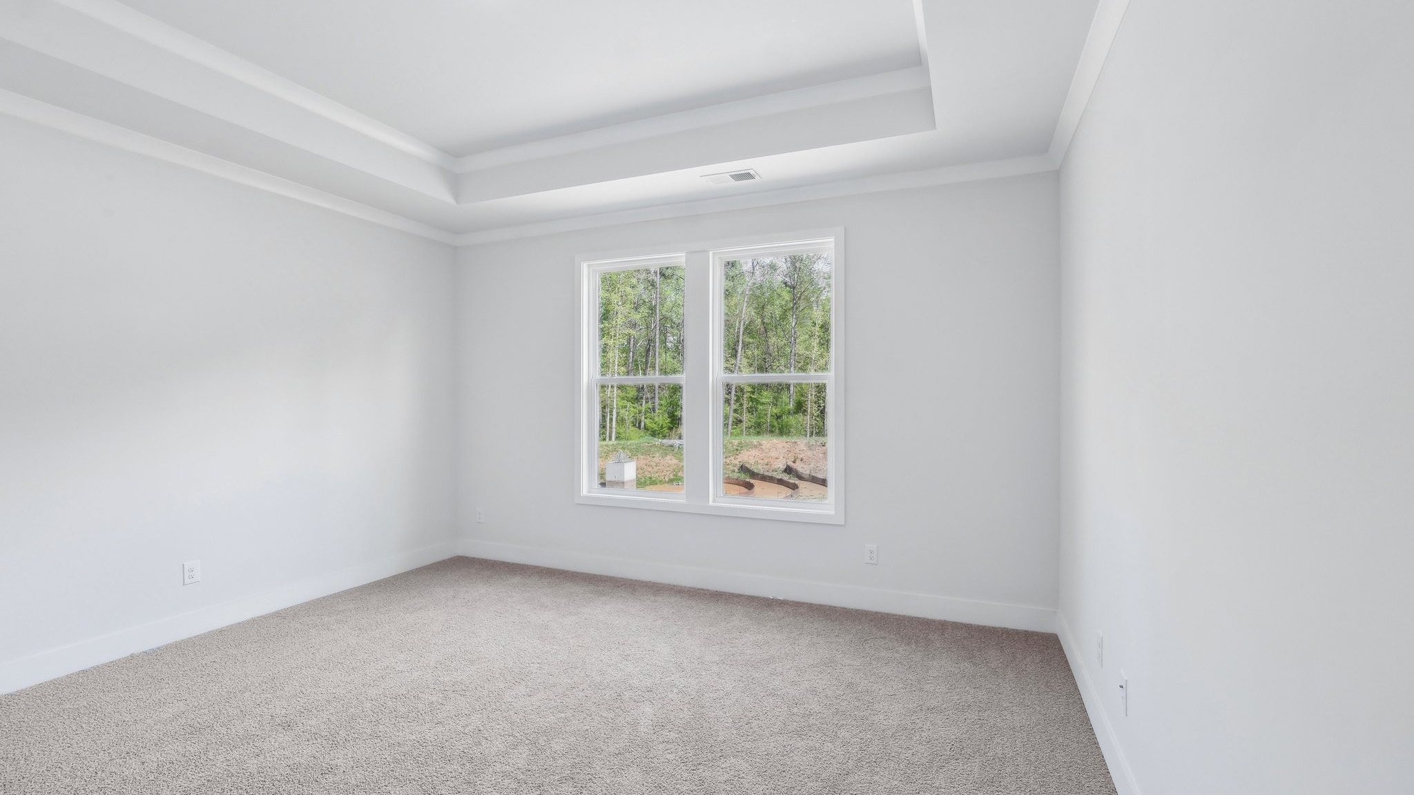 Carpeted bedroom with large window