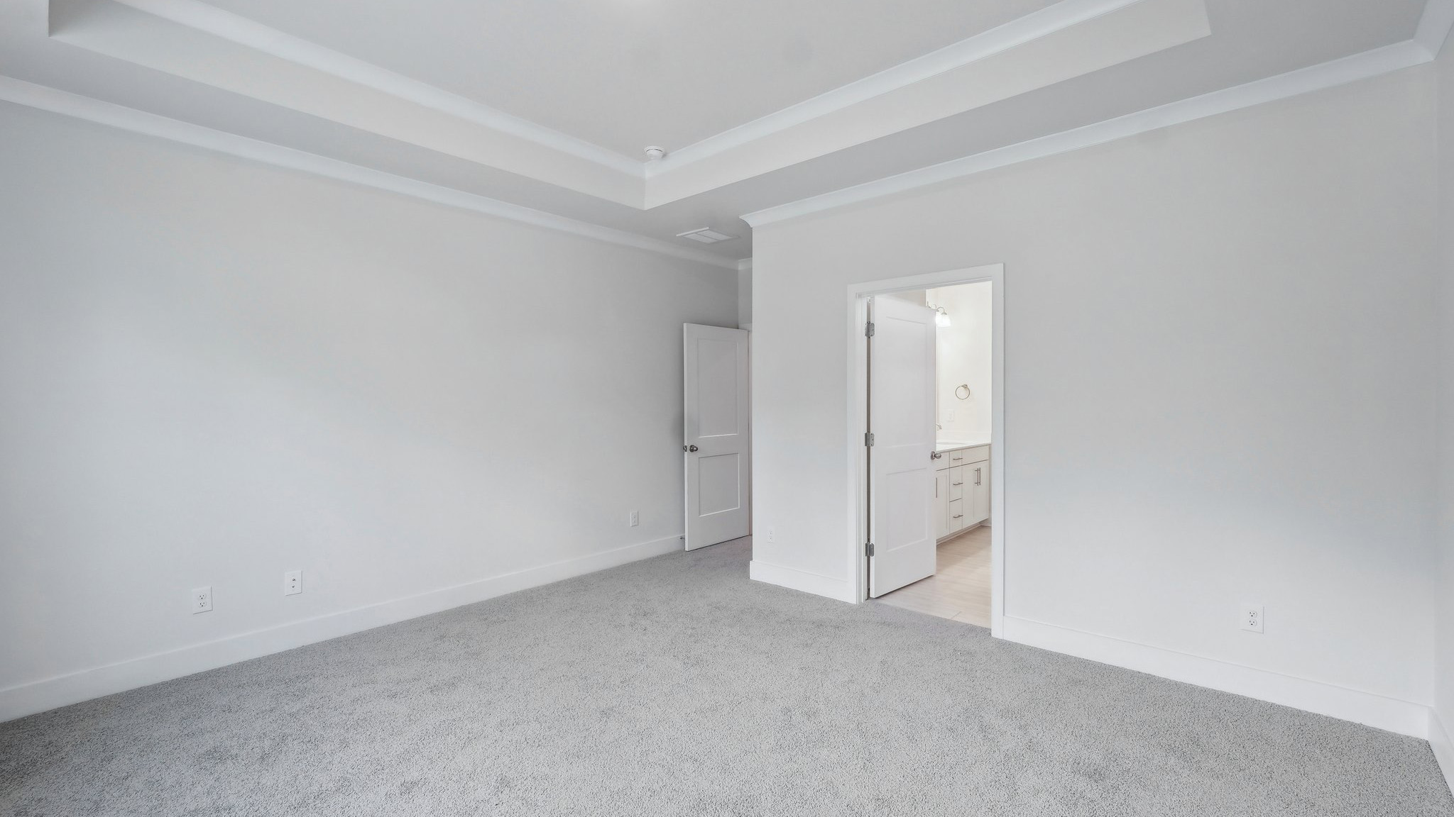 Carpeted bedroom with large window