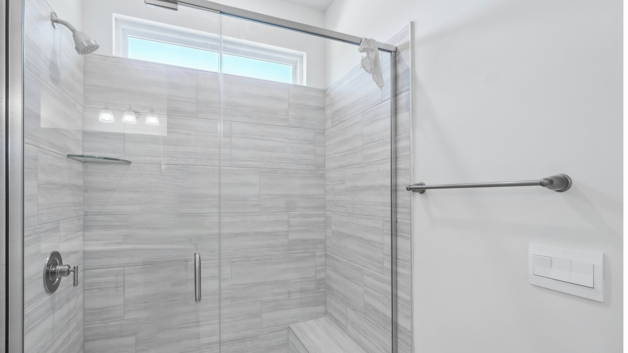 bathroom with double sink vanity and large shower