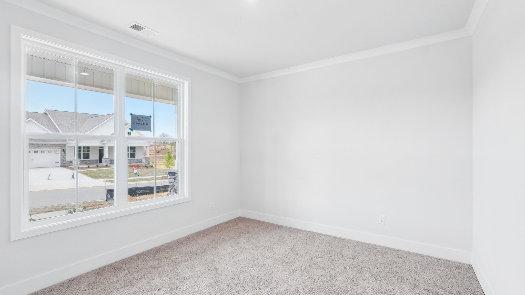 Carpeted bedroom with large window