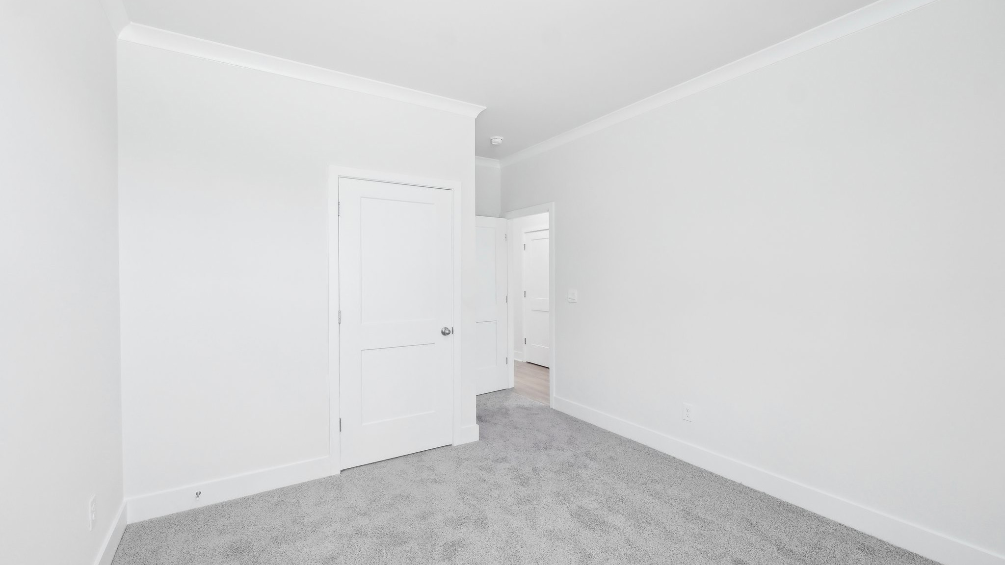 Carpeted bedroom with large window
