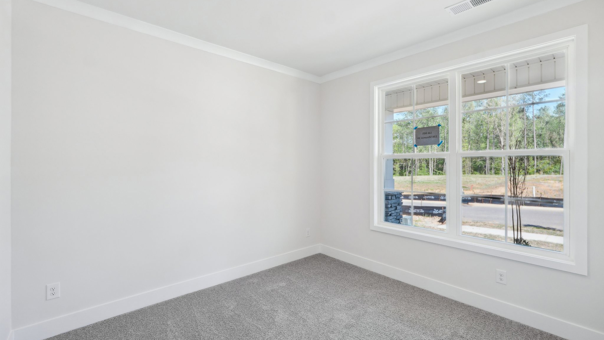 Carpeted bedroom with large windows