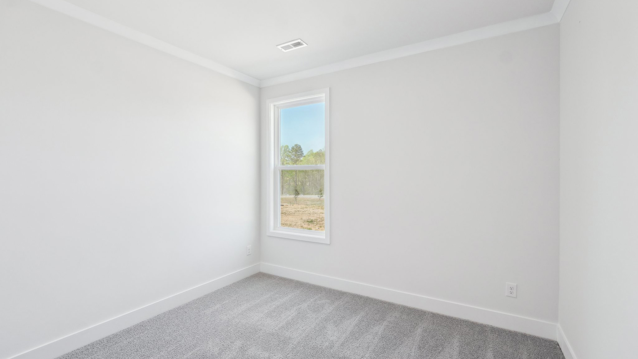 Carpeted bedroom with large windows