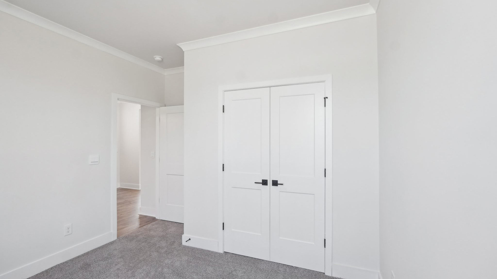 Carpeted bedroom with large windows