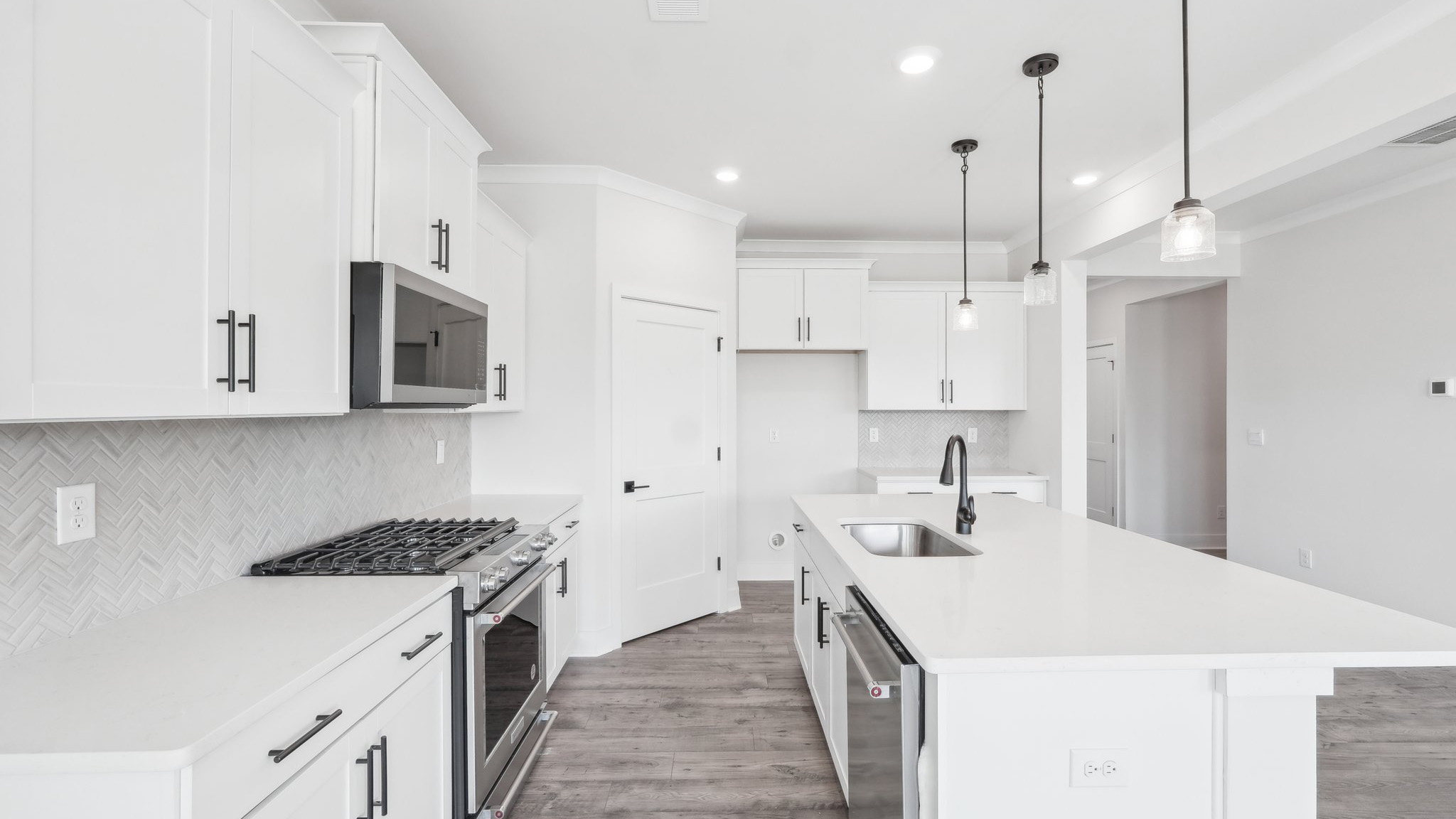 Kitchen and island with tile backsplash and stainless steel appliances