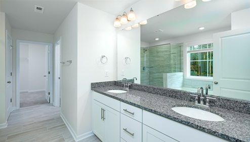 Bathroom with double sinks, white cabinets