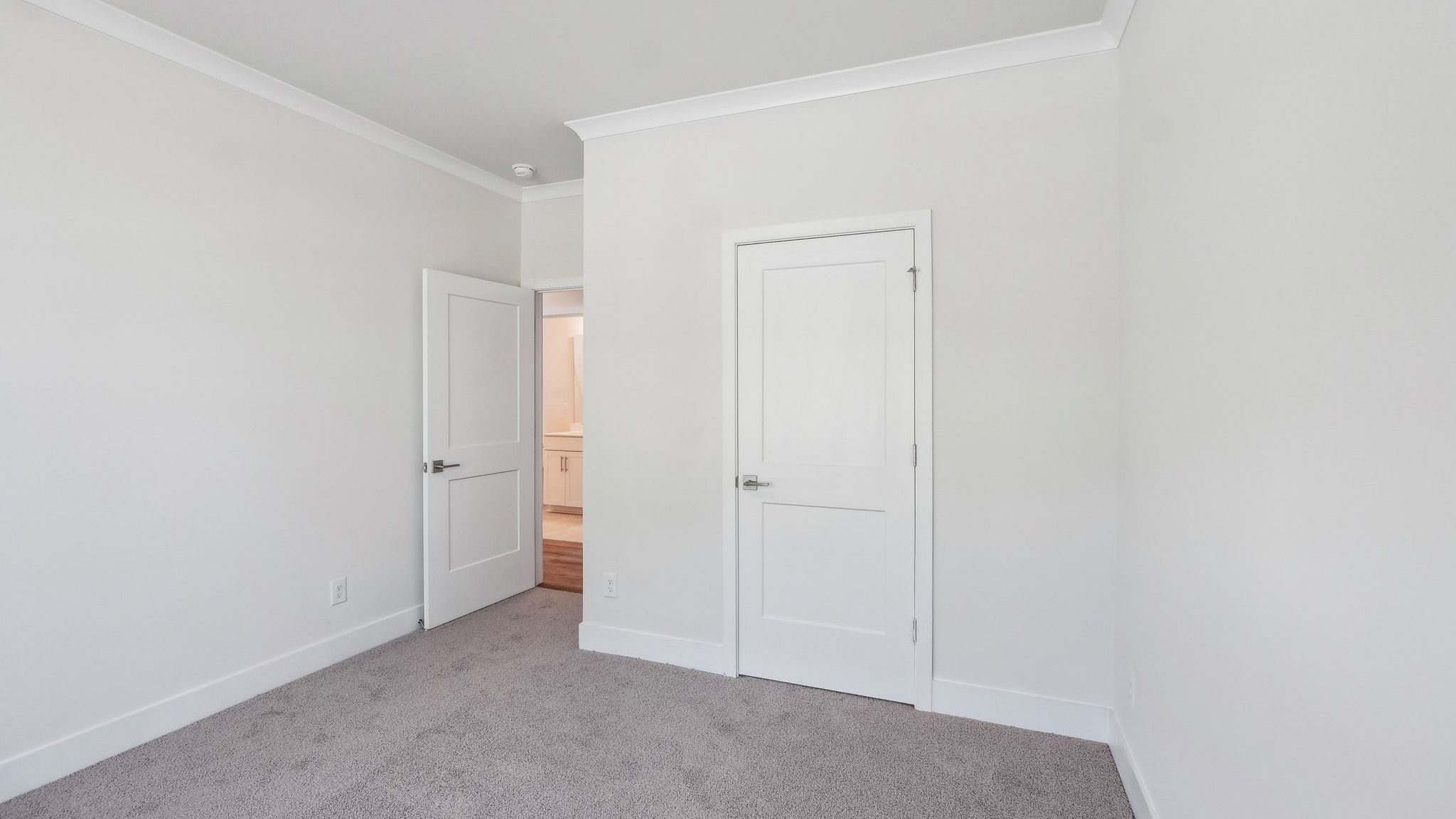 Carpeted bedroom with large window