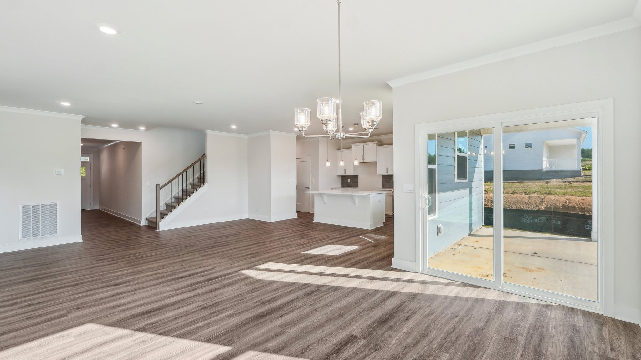 Family room beside kitchen with large windows