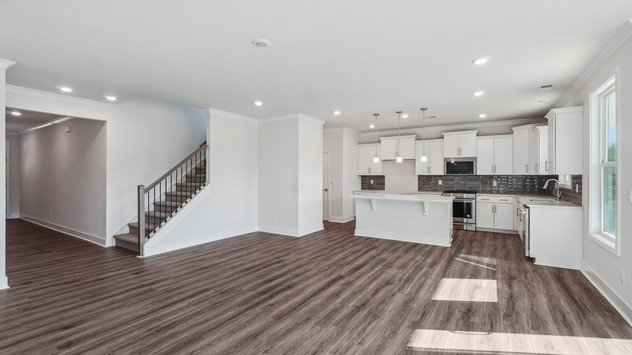 Family room beside kitchen with large windows