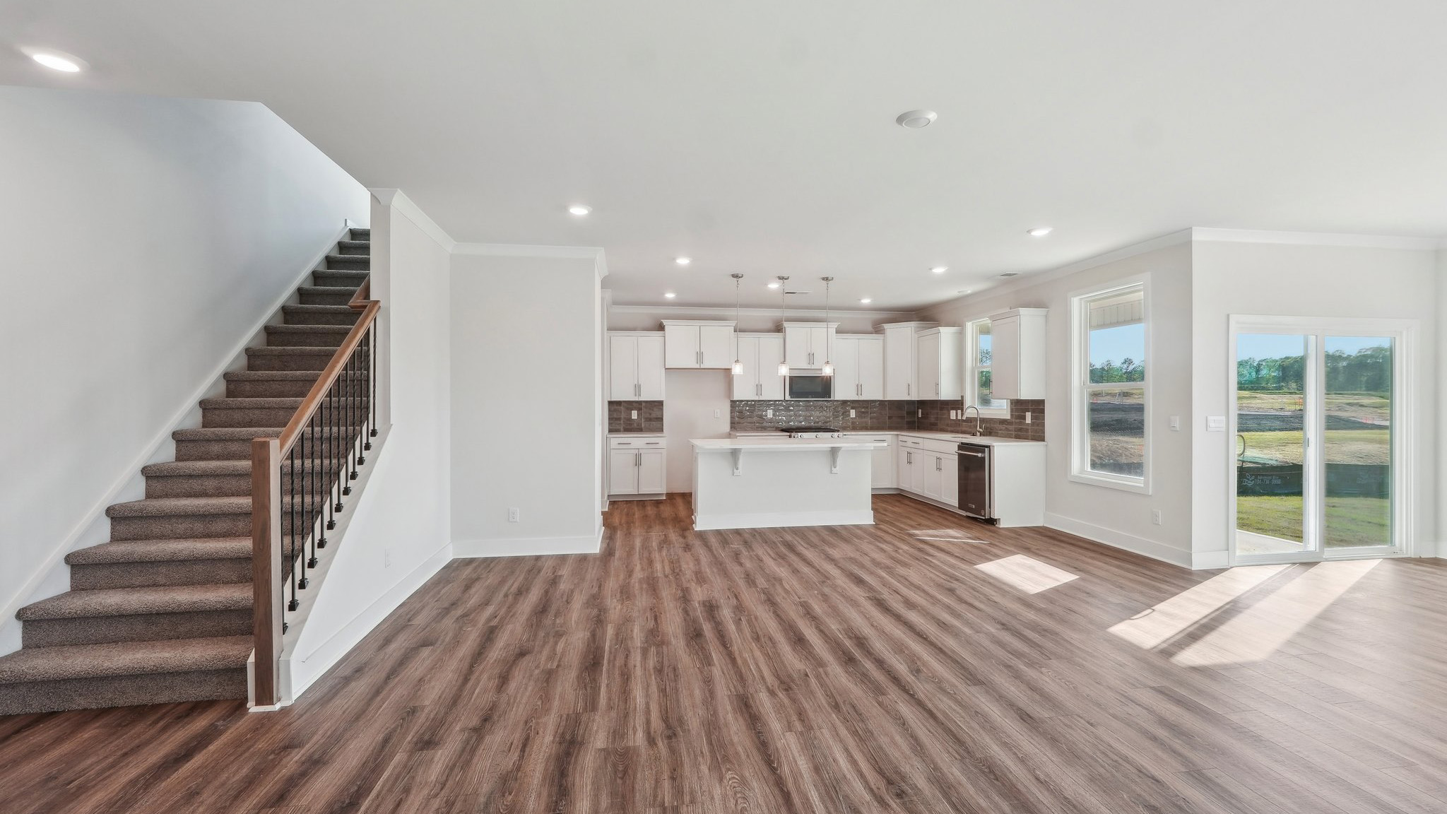 Family room beside kitchen with large windows