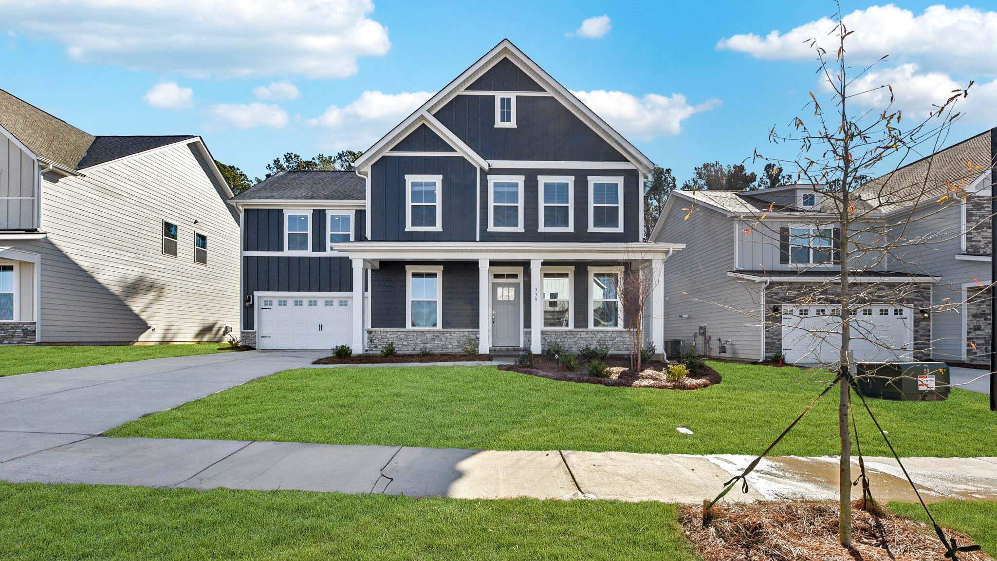 Greenwood front exterior with siding, brick and two car garage