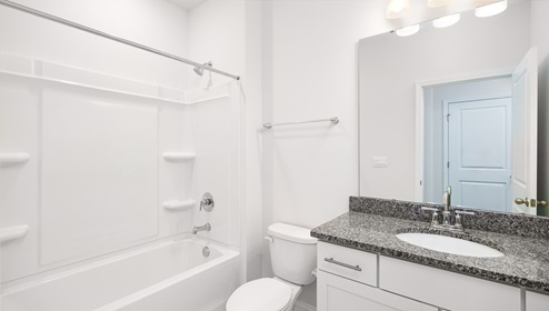 Bathroom with bathtub and white cabinet