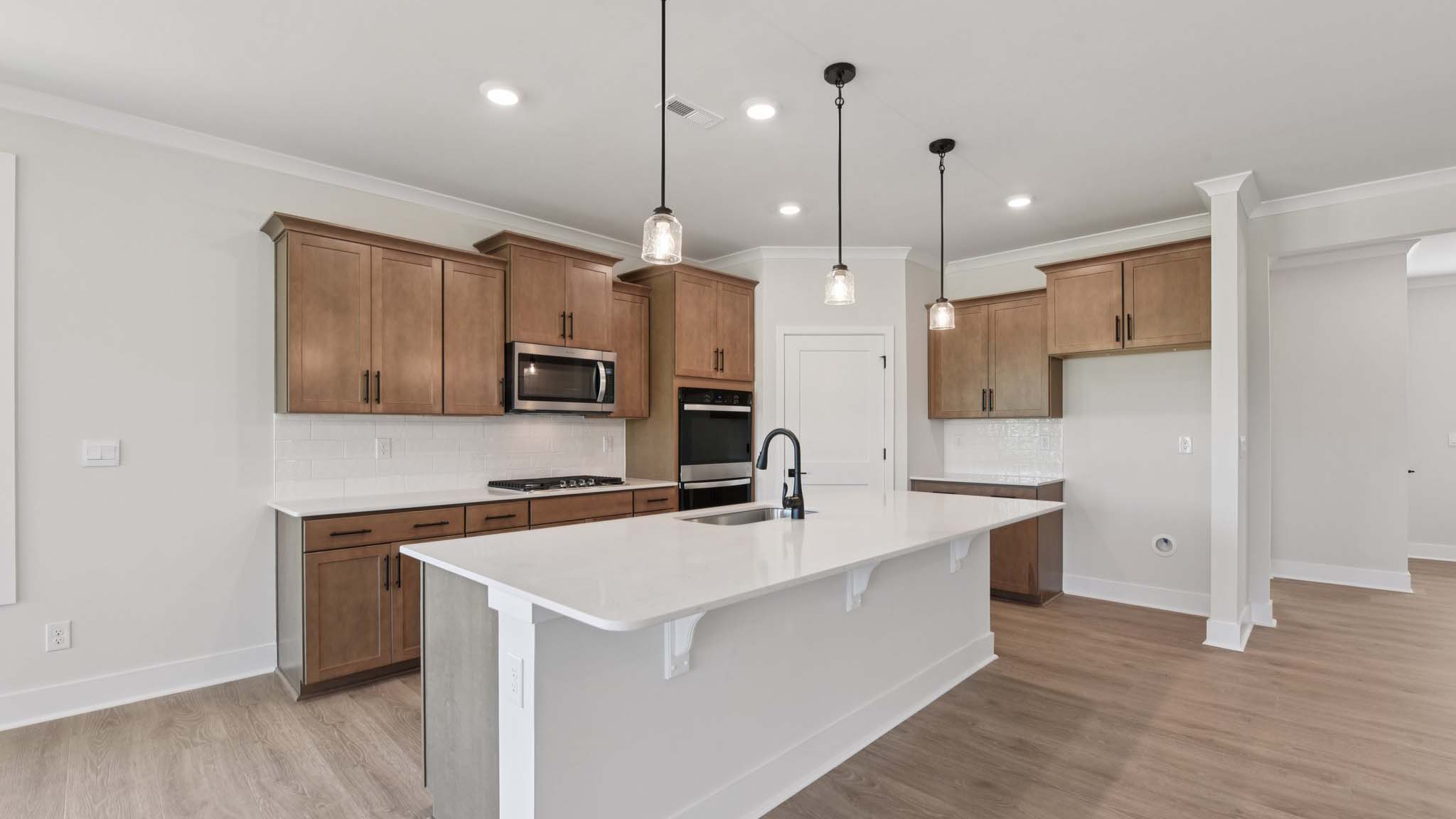 Large kitchen and island with stainless steel appliances