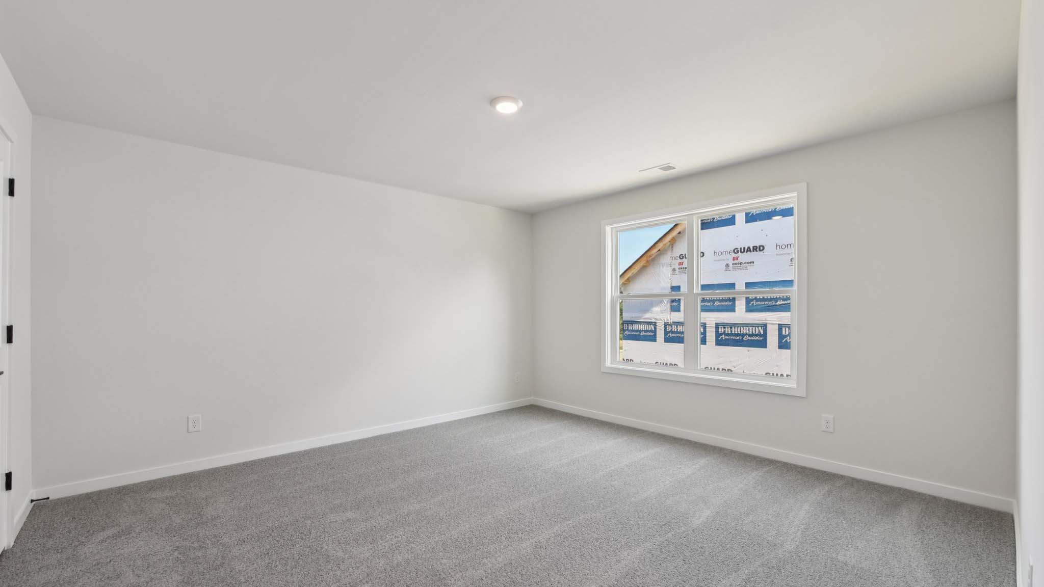 Carpeted bedroom with windows