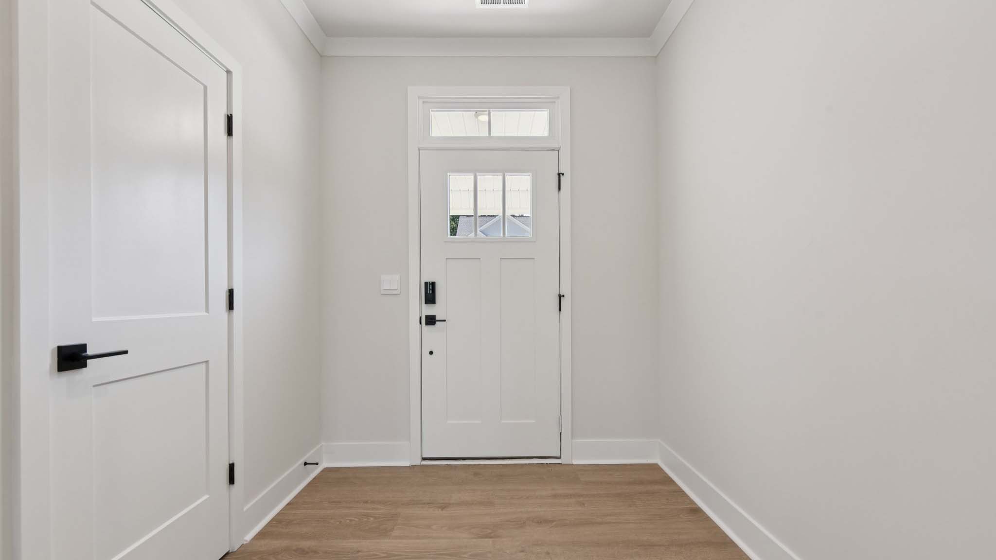 Welcoming foyer with view of living room