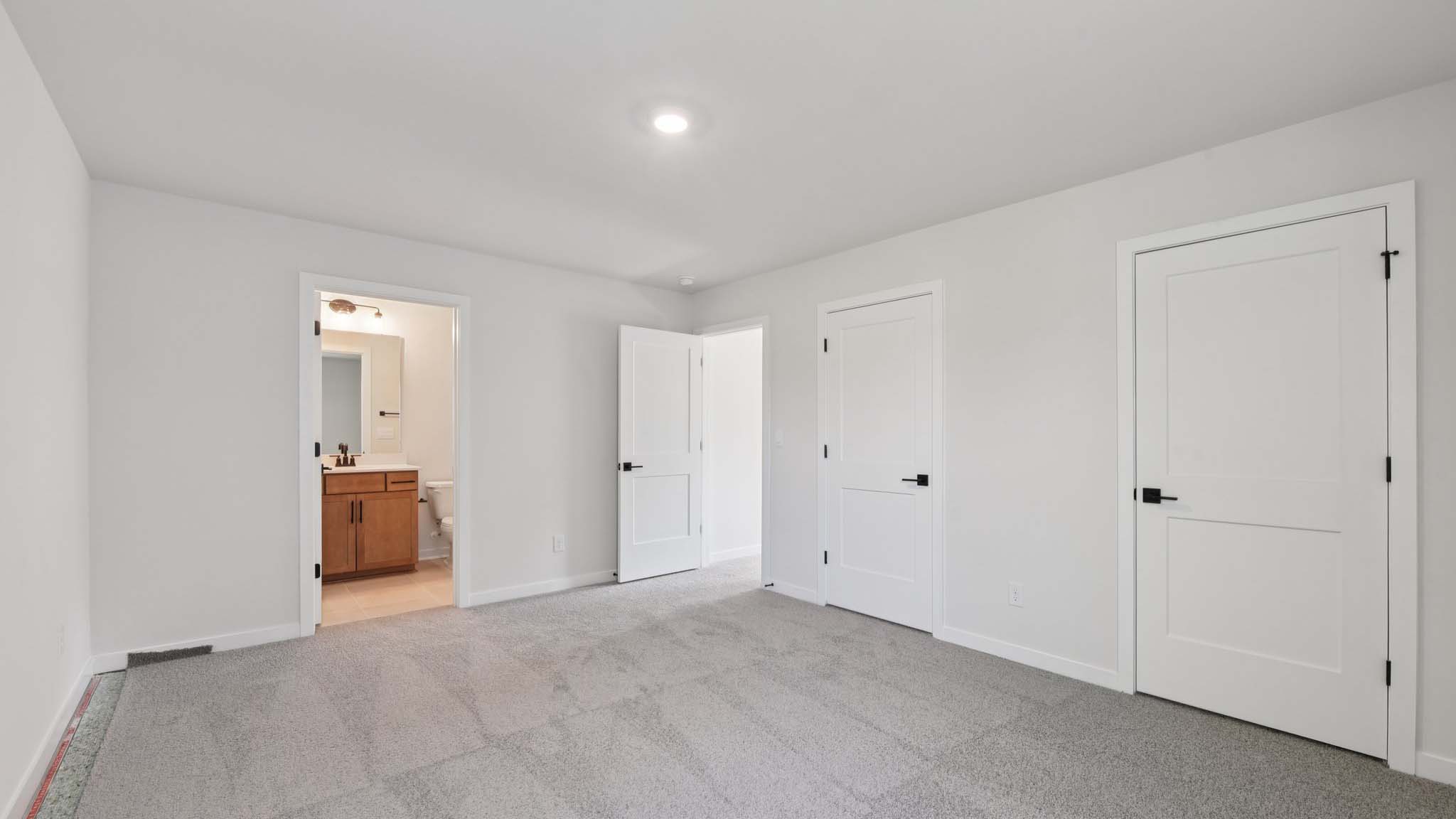 Carpeted bedroom with windows